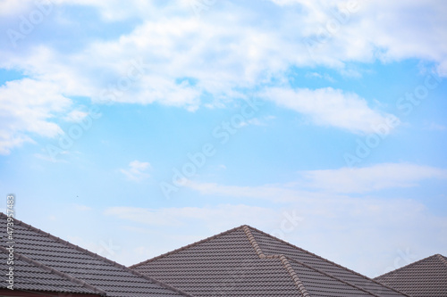 Fototapeta Ceramic roof tiles on the house with blue sky