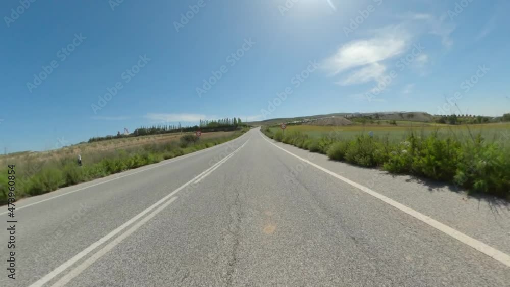 POV motorcycle ride along clear roads with cloudless blue skies on a sunny day POV motorcycle ride along clear roads with cloudless blue skies on a sunny day