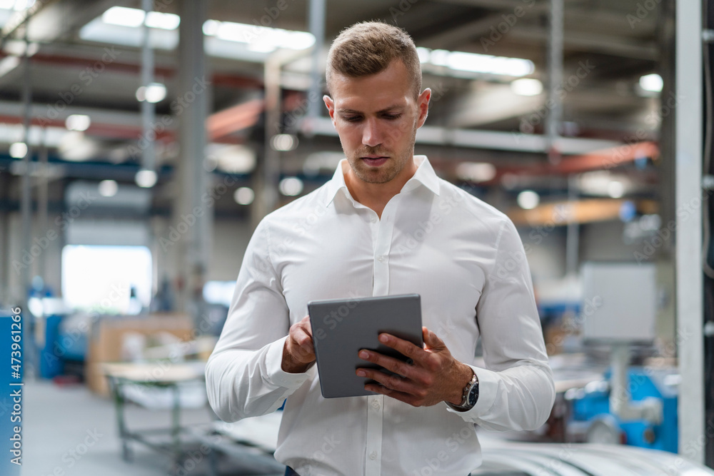 Young businessman using digital tablet at industry Young businessman using digital tablet at industry