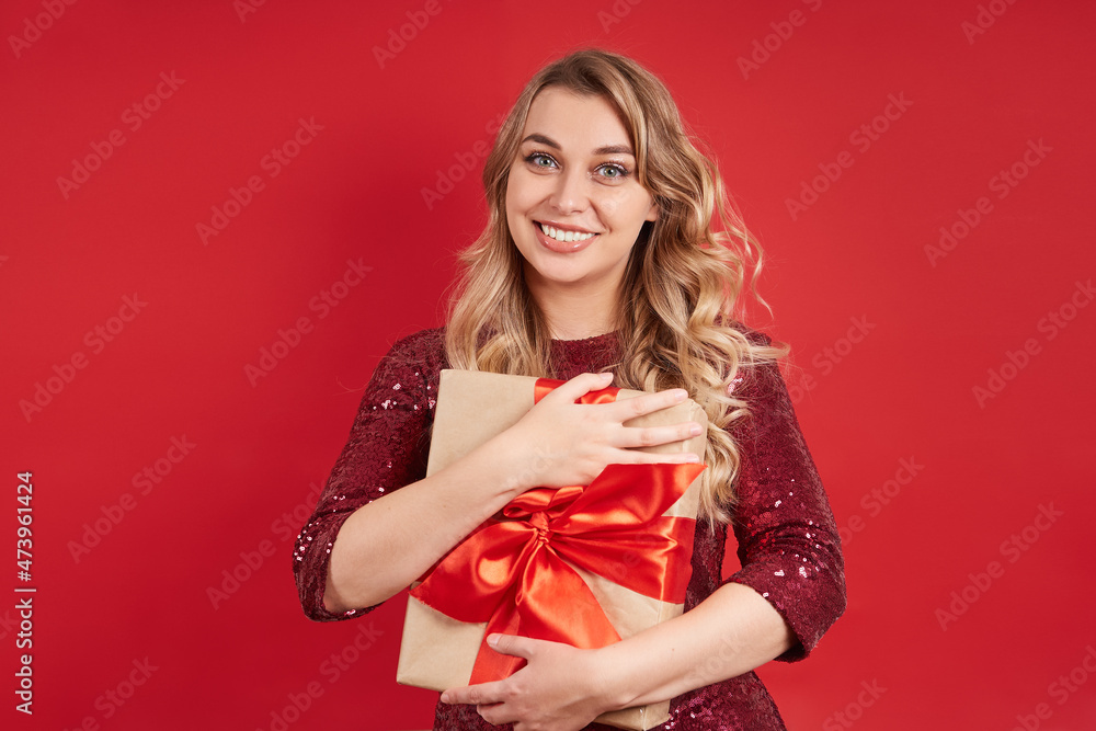 Cute smiling blonde holding a gift box for Christmas, birthday, Valentine's day. Cute smiling blonde holding a gift box for Christmas, birthday, Valentine's day.