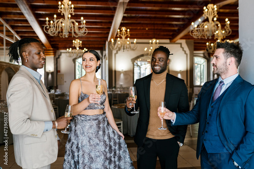 Elegant men and woman holding champagne flute at banquet photo