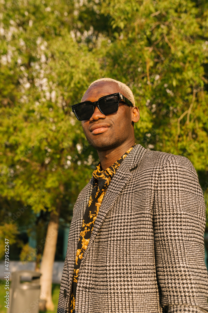 Fashionable man wearing sunglasses and blazer on sunny day Fashionable man wearing sunglasses and blazer on sunny day