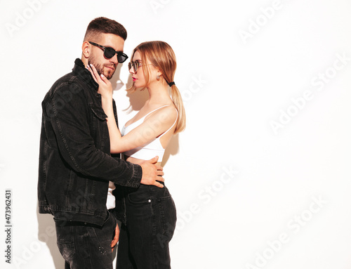Sexy confident beautiful woman and her handsome boyfriend. Happy cheerful family having tender moments in studio.Pure models hugging.Embracing each other in sunglasses. Isolated on white