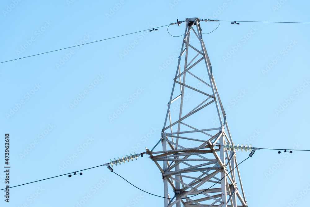 Support of an overhead power line. Transmission of electricity from a powerful power plant to the city. Poles with wires on the background of a beautiful sky. Support of an overhead power line. Transmission of electricity from a powerful power plant to the city. Poles with wires on the background of a beautiful sky.