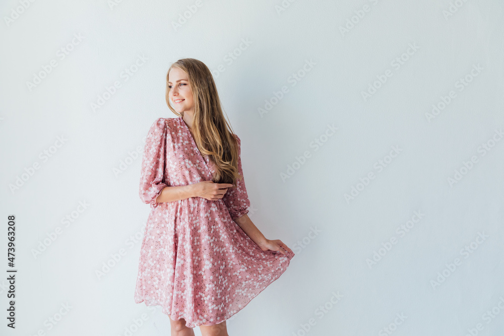 portrait of a beautiful blonde woman in a summer pink dress portrait of a beautiful blonde woman in a summer pink dress