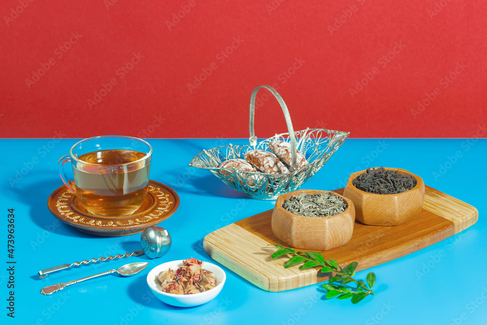 Tea in a cup in a composition with pastries and dessert, on a bright colored background. Tea in a cup in a composition with pastries and dessert, on a bright colored background.