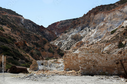 abandoned sulfur mine with a rusted and weathered silo next to the red cliffs photo