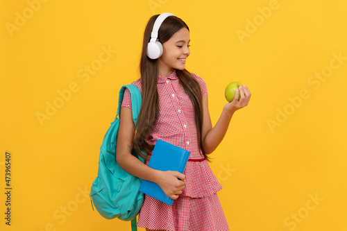 september 1. healthy childhood. child with school bag. music. cheerful teen girl carry backpack.