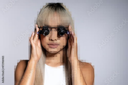 Pixelated young woman adjusting magnifying eyeglasses over white background