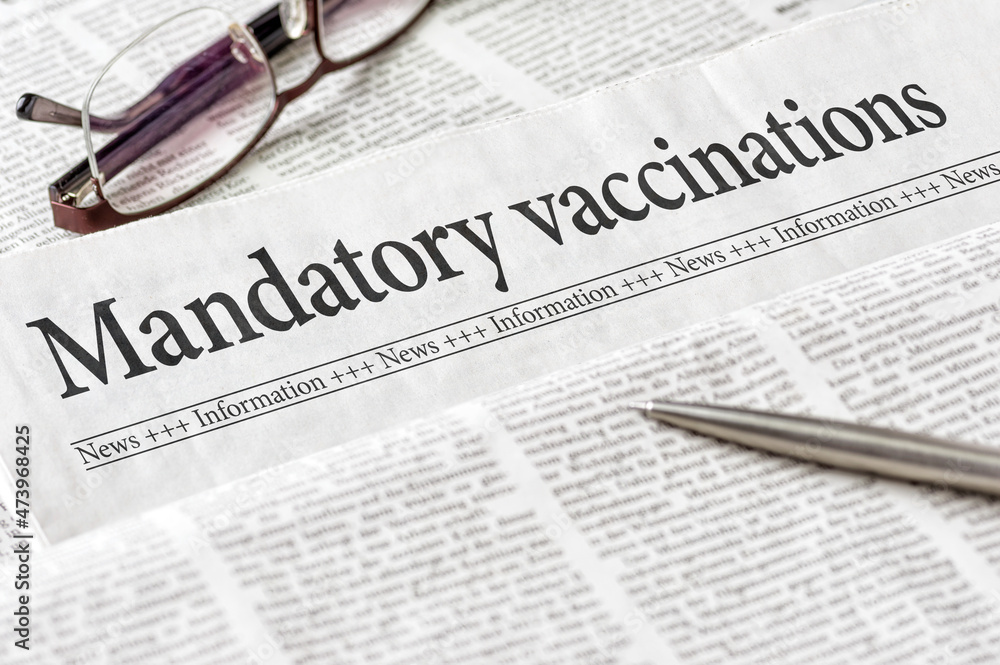 A newspaper with the headline Mandatory vaccination A newspaper with the headline Mandatory vaccination