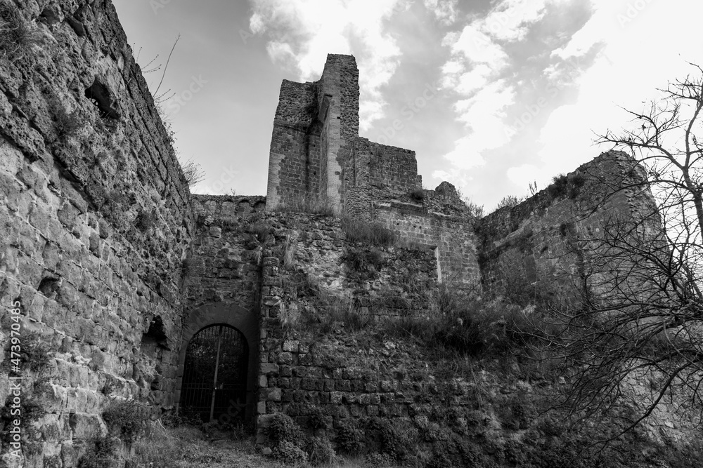 black and white image of Rocca Aldobrandesca, the remains of old castle of the medieval village of Sovana founded in Etruscan times. Tuff city in Tuscany. Italy