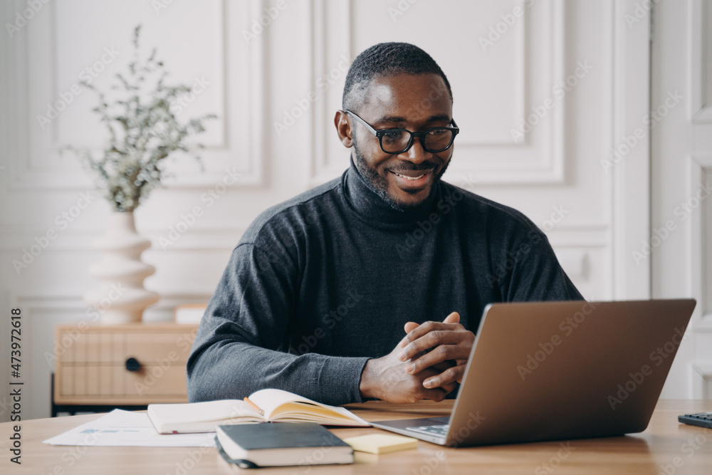 Positive African American male private consultant having session online listens to client attentively Positive African American male private consultant having session online listens to client attentively