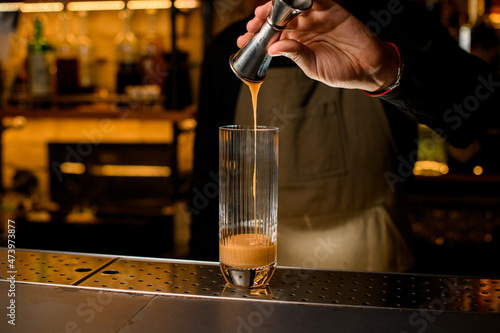 Wallpaper Mural hand of bartender skilfully poured syrup into tall transparent glass on the bar Torontodigital.ca