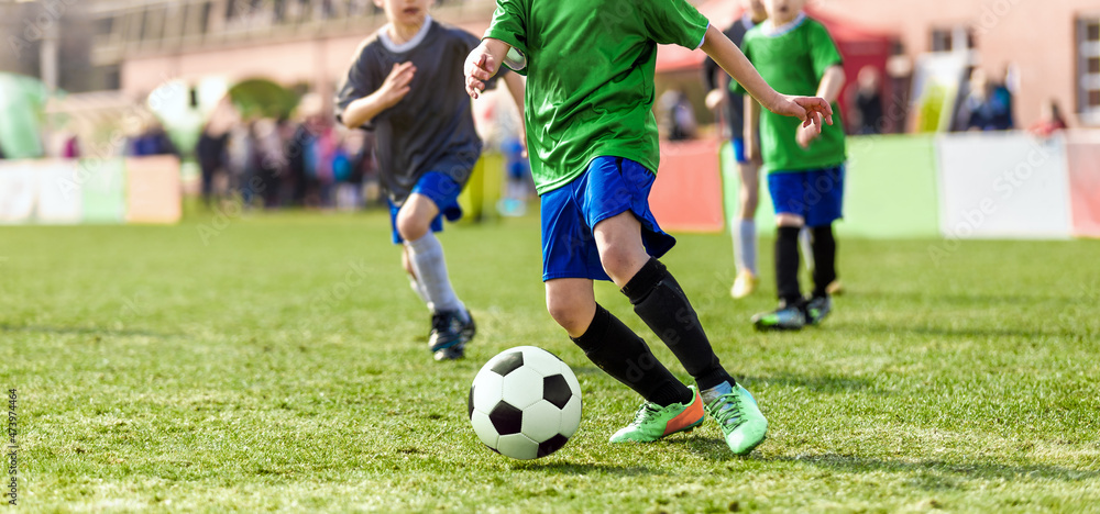 Group of chool Kids Running Football Ball and Compete in School Soccer Tournament. Boys in Sports Jersey Running on Grass Field and Kicking Ball Group of chool Kids Running Football Ball and Compete in School Soccer Tournament. Boys in Sports Jersey Running on Grass Field and Kicking Ball
