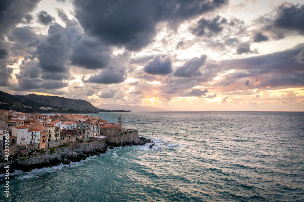 Evening landscape overlooking typical Sicilian houses by the sea in Cefalu, Italy. Tyrrhenian Sea at sunset