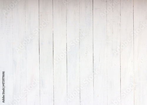 Old white and grey wooden background with cracks and scratches in vintage style