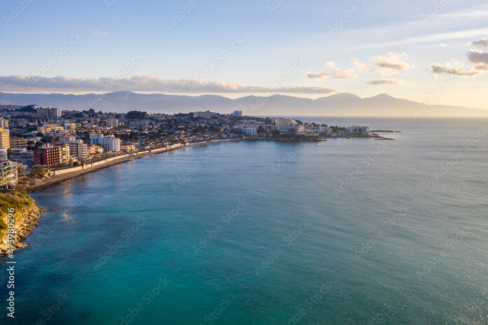 Turkey, Aydin Province, Kusadasi, Aerial view of coastal town in summer with mountains in distant background Turkey, Aydin Province, Kusadasi, Aerial view of coastal town in summer with mountains in distant background