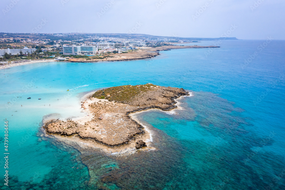 Aerial view of the most famous beaches in Cyprus - Nissi Beach. White sand beach with azure waters. Beautiful beach and panoramic views of Cyprus