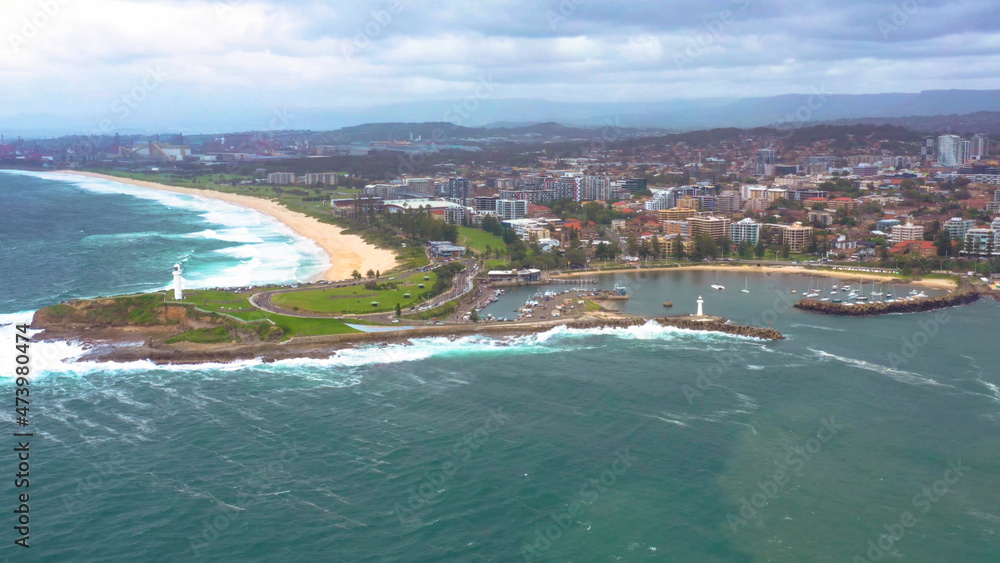 Aerial drone view of Flagstaff Point Lighthouse and Breakwater Lighthouse at Wollongong on the New South Wales South Coast, Australia, looking south to Port Kembla on a cloudy morning  