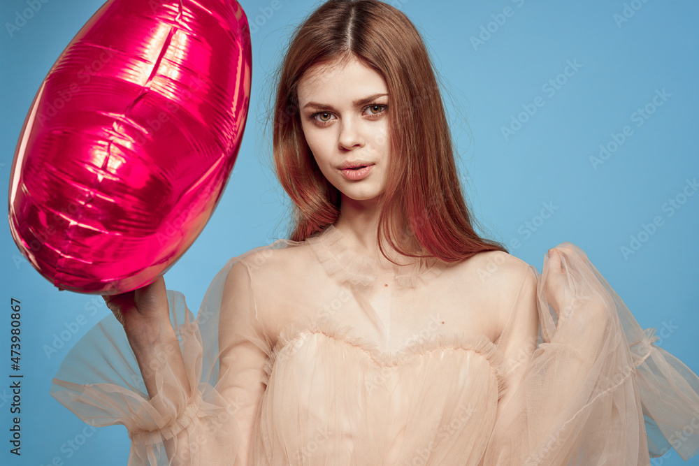 beautiful woman red heart in the hands of the balloon blue background beautiful woman red heart in the hands of the balloon blue background