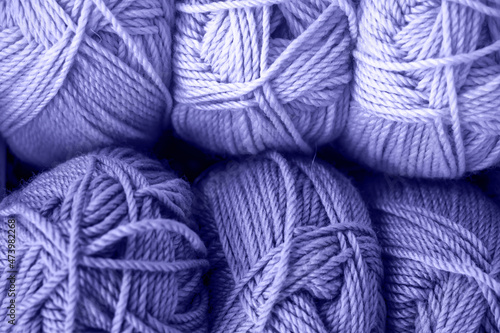 Many balls of wool yarn for knitting. Trendy color of year 2022.