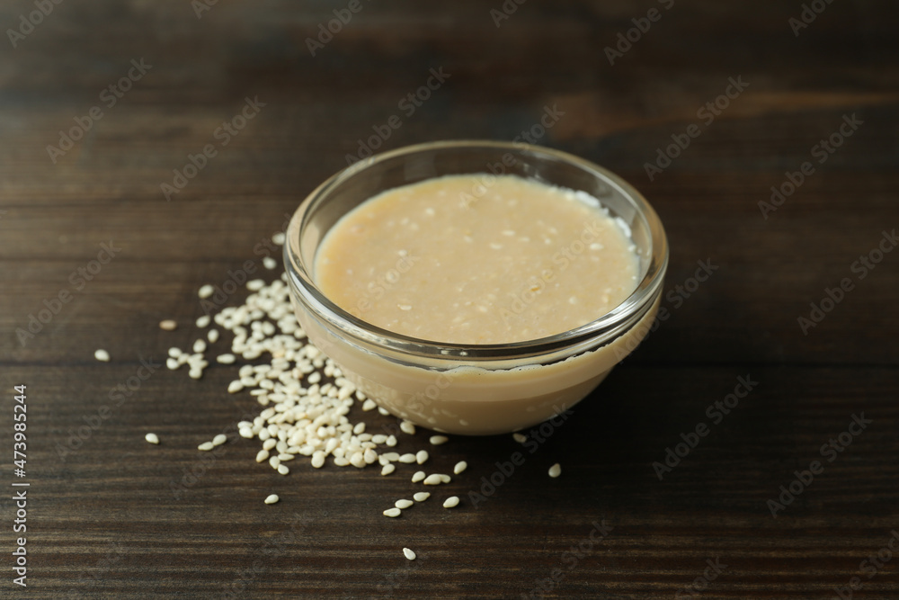 Concept of tasty food with tahini sauce on wooden background Concept of tasty food with tahini sauce on wooden background