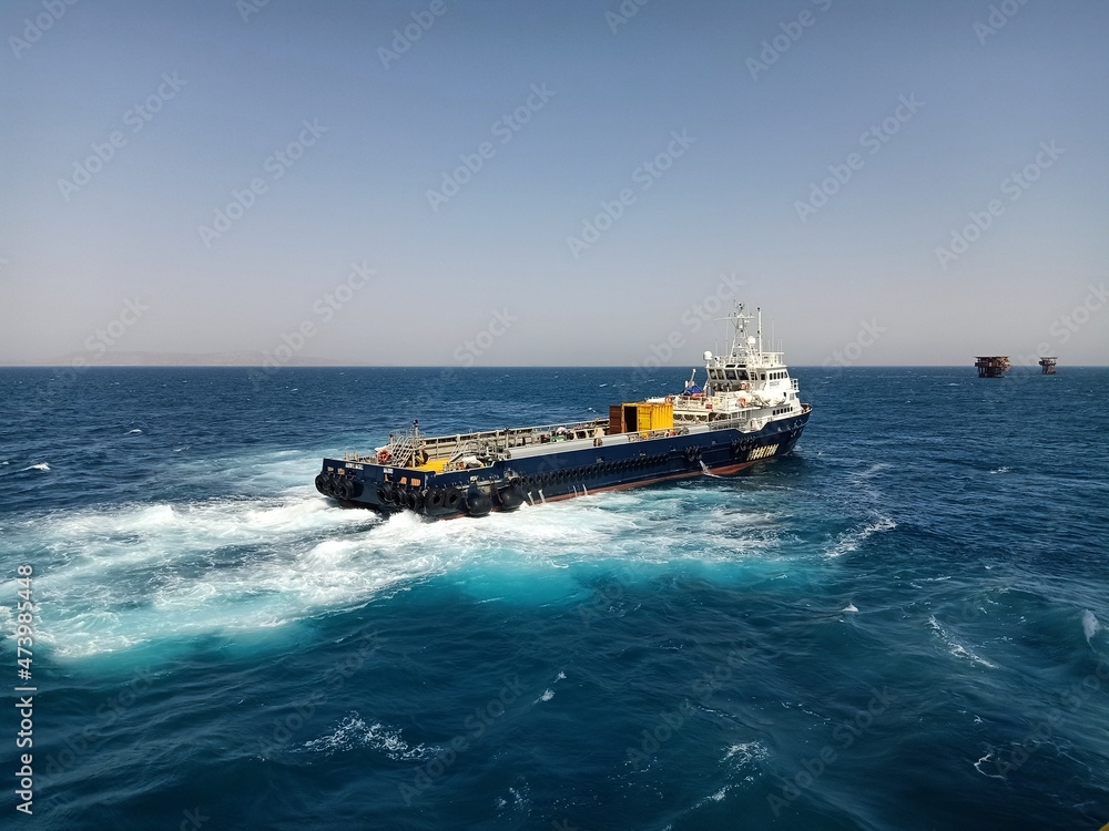a supply vessel is heading to an offshore oil platform