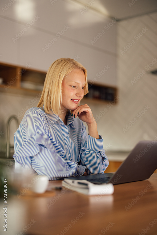 Concentrated caucasian woman, reading her e-mails, at home office. Concentrated caucasian woman, reading her e-mails, at home office.