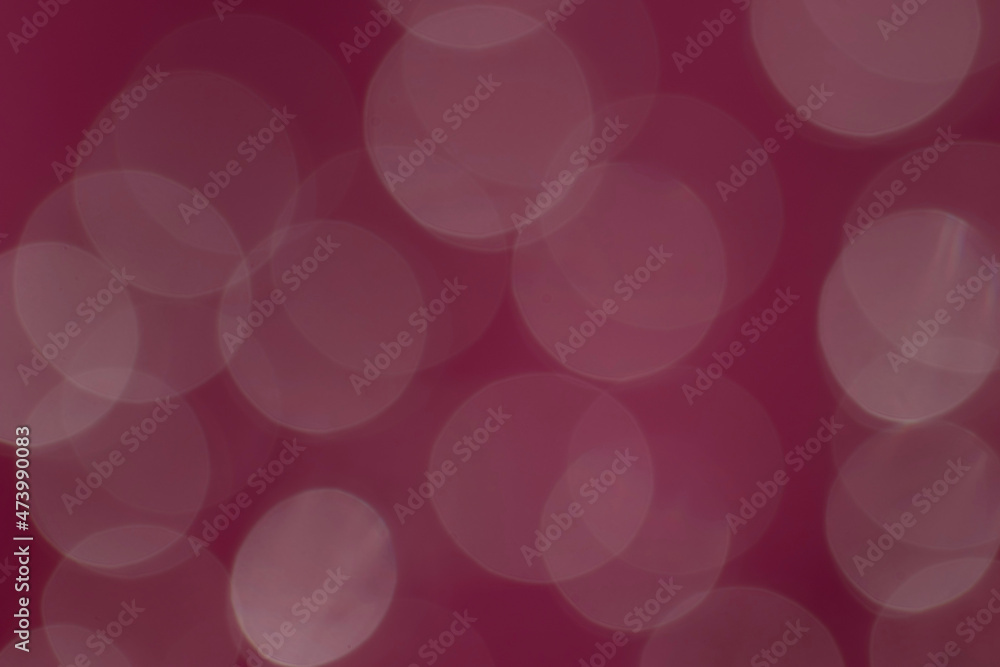 Abstract bokeh circles background on crimson background Abstract bokeh circles background on crimson background