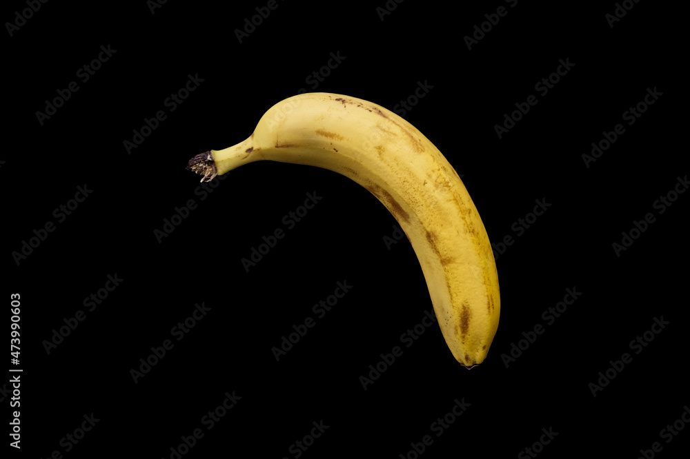 Falling banana on a black background. Background for t-shirt, print, cover. Falling banana on a black background. Background for t-shirt, print, cover.