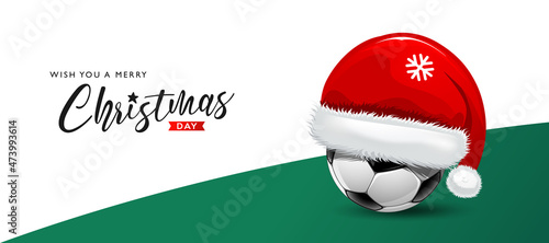 Soccer ball with santa claus hat, merry christmas concept design on white and green background, Eps 10 vector illustration
