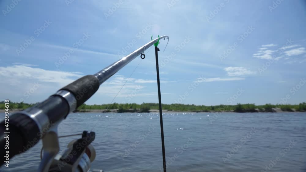 Fishing on the river in summer. The concept of hobbies and leisure. Copy space. Selective focus Fishing on the river in summer. The concept of hobbies and leisure. Copy space. Selective focus