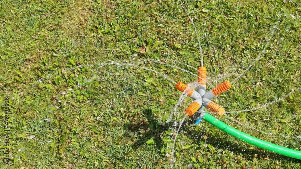 Slow video water sprinkler. Irrigation system on green grass. Garden lawn spray. Plastic climate rain. Underground shower. Refreshing technology Slow video water sprinkler. Irrigation system on green grass. Garden lawn spray. Plastic climate rain. Underground shower. Refreshing technology