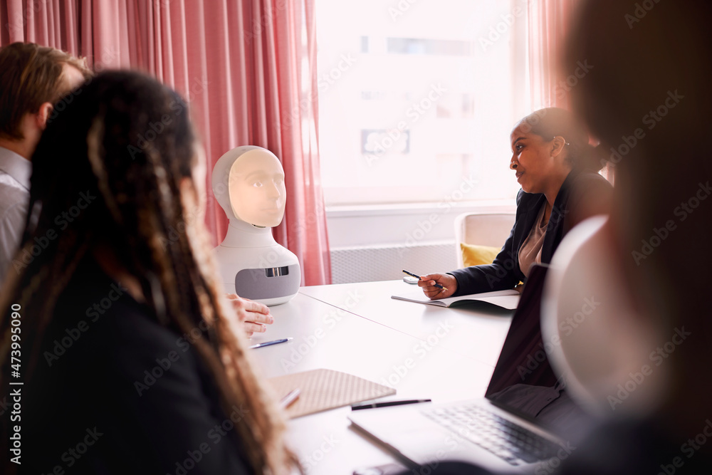Business people discussing robot voice assistant during meeting Business people discussing robot voice assistant during meeting