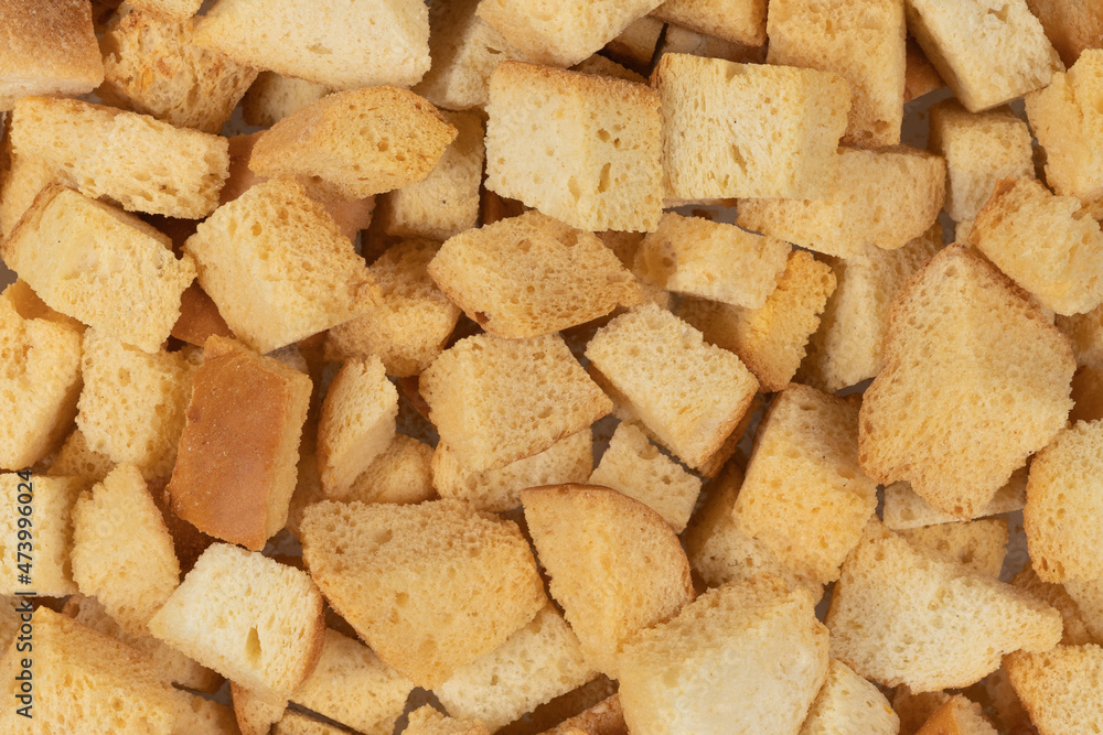Background texture of baked crackers. heap small pieces dried bread. crumbs of bread croutons Background texture of baked crackers. heap small pieces dried bread. crumbs of bread croutons