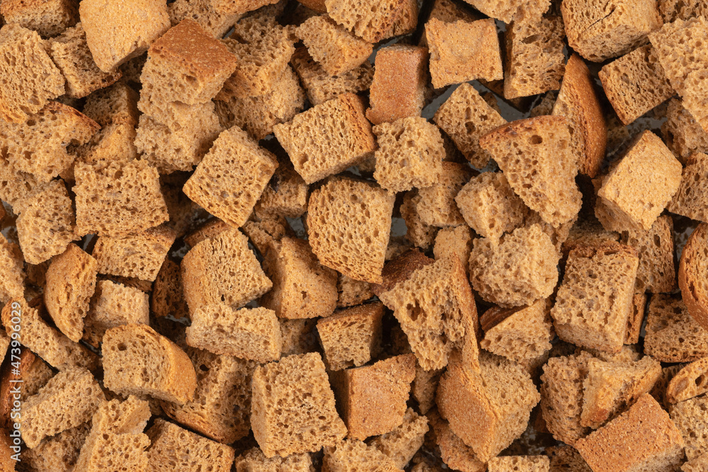 Background texture of baked crackers. heap small pieces dried bread. crumbs of bread croutons Background texture of baked crackers. heap small pieces dried bread. crumbs of bread croutons