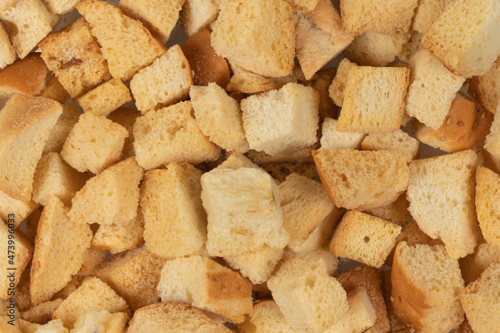 Background texture of baked crackers. heap small pieces dried bread. crumbs of bread croutons Background texture of baked crackers. heap small pieces dried bread. crumbs of bread croutons