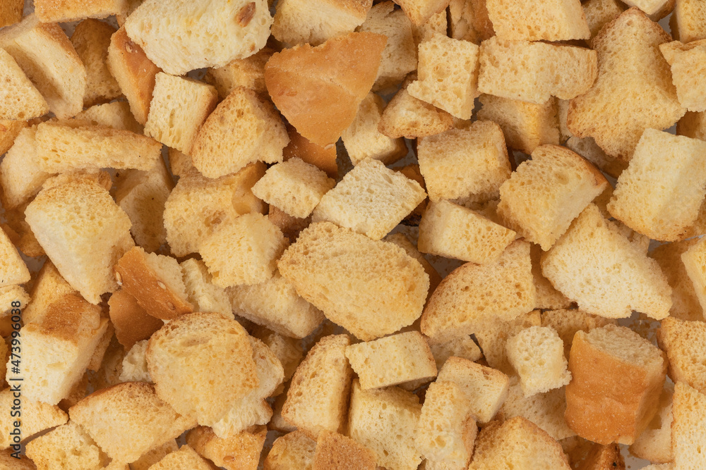 Background texture of baked crackers. heap small pieces dried bread. crumbs of bread croutons Background texture of baked crackers. heap small pieces dried bread. crumbs of bread croutons