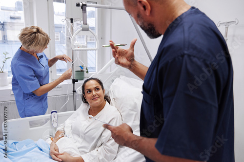 Female patient talking to nurse photo