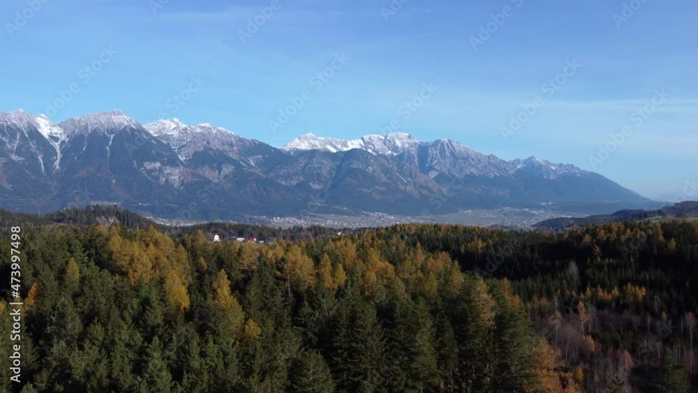Flying Over Pine Trees In Autumn Foliage With View Of Rugged Valley In Innsbruck, Austria. aerial drone 4k Flying Over Pine Trees In Autumn Foliage With View Of Rugged Valley In Innsbruck, Austria. aerial drone 4k