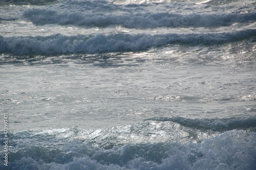 A stormy surface with waves of the sea and bubbles