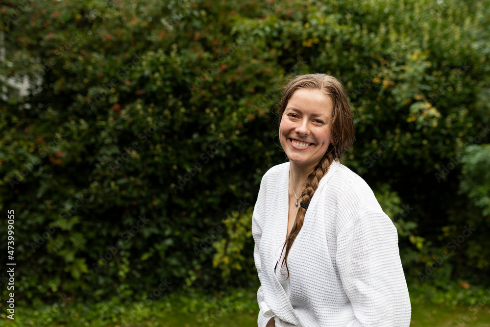Portrait of smiling young woman in white bathrobe Portrait of smiling young woman in white bathrobe