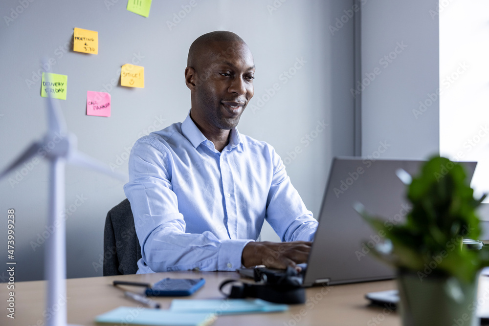 Businessman working on laptop at office Businessman working on laptop at office