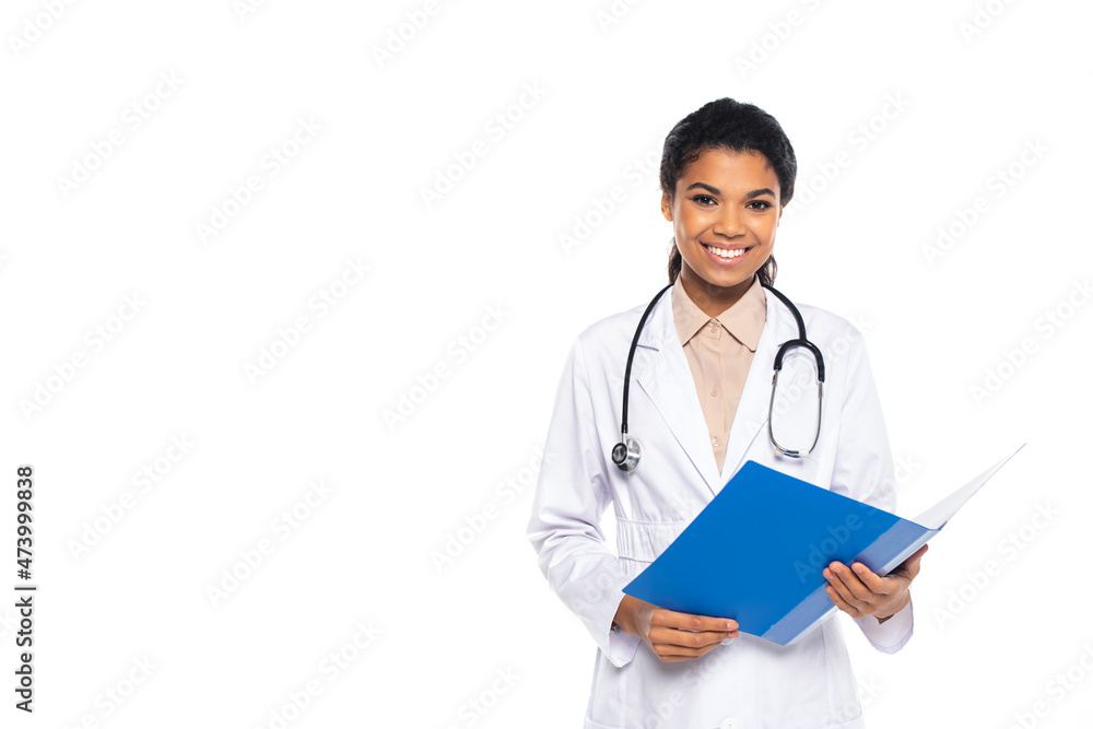 Smiling african american oculist holding paper folder isolated on white. Smiling african american oculist holding paper folder isolated on white.
