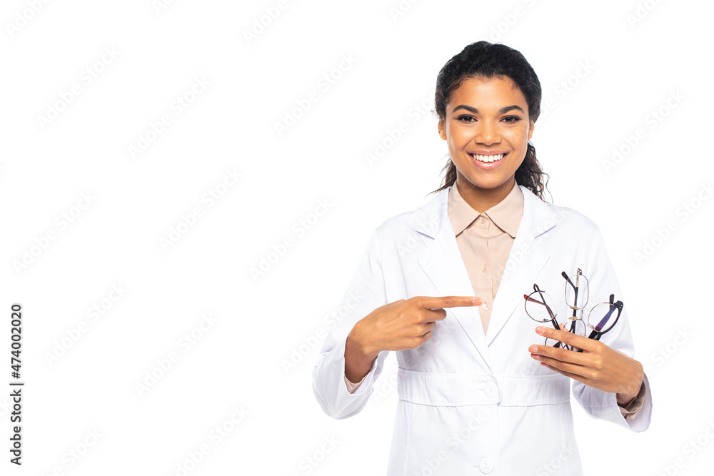 Smiling african american doctor pointing at eyeglasses isolated on white. Smiling african american doctor pointing at eyeglasses isolated on white.