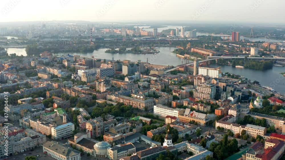 Top view of Podol. Many buildings and churches. Evening view of the river Dnipro. Top view of Podol. Many buildings and churches. Evening view of the river Dnipro.