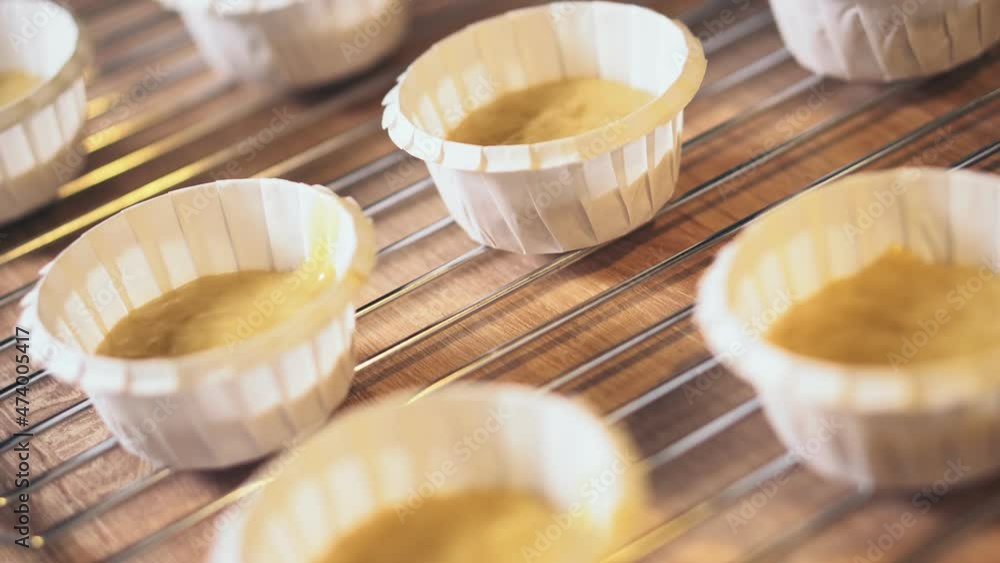 Banana muffins dough in paper molds, close-up. Preparing banana cupcakes process. Banana muffins dough in paper molds, close-up. Preparing banana cupcakes process.