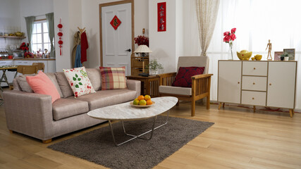 interior of a cozy bright home interior with chinese lunar new year decorations in living room and kitchen. chinese text translation: spring and congratulations everyone
