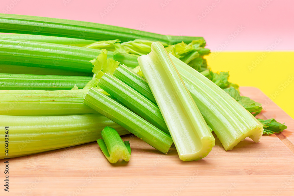 Fresh Celery Stem and Chopped Celery Sticks on Wooden Cutting Board. Vegan and Vegetarian Culture. Raw Food. Healthy Diet with Negative Calorie Content. Slimming Food Fresh Celery Stem and Chopped Celery Sticks on Wooden Cutting Board. Vegan and Vegetarian Culture. Raw Food. Healthy Diet with Negative Calorie Content. Slimming Food