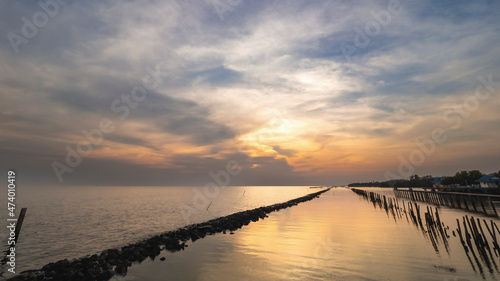 Sea view with rock and bamboo line to slow waves when twilight  Samut Sakhon  Thailand